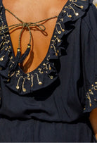 black gold v back holiday dress to werar on a Caribbean cruise by Lindsey  Brown resort wear 